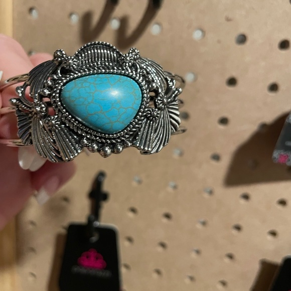 Ornate silver cuff with abstract shaped turquoise crackle stone.